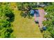 An aerial view of a well-manicured lawn, shaded by mature trees with a structure visible in the background at 7158 S Leewynn Dr, Sarasota, FL 34240