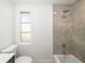 Bathroom with a tub, shower, updated fixtures, and window providing natural light at 7158 S Leewynn Dr, Sarasota, FL 34240