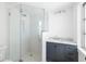 Modern bathroom features a glass walk-in shower and a dark vanity with white countertop and light tile at 7158 S Leewynn Dr, Sarasota, FL 34240