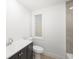 Bathroom features a vanity with a dark cabinet, toilet, and a tiled shower with glass doors at 7158 S Leewynn Dr, Sarasota, FL 34240