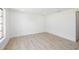 Empty bedroom features wood-look floors, a neutral color scheme, and a window for natural light at 7158 S Leewynn Dr, Sarasota, FL 34240