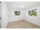 Bedroom featuring wood-look floors and two windows providing natural light and lovely outdoor views at 7158 S Leewynn Dr, Sarasota, FL 34240