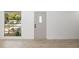 Bright entryway has light wood floors, and large window and glass front door that lets in natural light at 7158 S Leewynn Dr, Sarasota, FL 34240