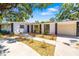 Well-maintained house with stone accents, lush landscaping, a long driveway, and inviting curb appeal at 7158 S Leewynn Dr, Sarasota, FL 34240