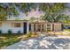Charming home with lush landscaping, a walkway, and a cozy, welcoming facade at 7158 S Leewynn Dr, Sarasota, FL 34240
