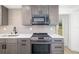 Close-up of a modern kitchen with stainless steel appliances and stylish gray cabinetry at 7158 S Leewynn Dr, Sarasota, FL 34240