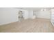 Bright, open-concept living space featuring modern light fixtures and light-colored hardwood floors at 7158 S Leewynn Dr, Sarasota, FL 34240