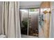 Bright bathroom featuring a peaceful garden view from a glass-enclosed atrium at 721 N Jefferson Ave # 721, Sarasota, FL 34237