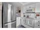 Modern kitchen with stainless steel refrigerator, white cabinets, and sleek appliances offers a blend of style and convenience at 721 N Jefferson Ave # 721, Sarasota, FL 34237