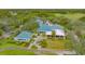 Expansive aerial view of the clubhouse, showcasing meticulous landscaping and outdoor seating areas at 7319 Westminster Ct, University Park, FL 34201