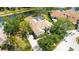 Overhead view of estate-style home featuring tile roof, mature landscaping, and circular driveway at 7319 Westminster Ct, University Park, FL 34201