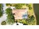 Aerial view of the home showcasing a private pool, tile roof, and mature landscaping at 7319 Westminster Ct, University Park, FL 34201