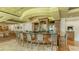Elegant bar area showcasing stylish seating, a well-stocked counter, and a sophisticated atmosphere for relaxation and socializing at 7319 Westminster Ct, University Park, FL 34201