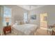 A serene bedroom featuring white linens, soft tones, and a bright ambiance at 7319 Westminster Ct, University Park, FL 34201