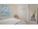 A bright bedroom featuring a large window and neutral tones at 7319 Westminster Ct, University Park, FL 34201