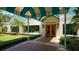 Welcoming entrance to The Varsity Club features a charming facade, well-manicured landscaping, and inviting doorway at 7319 Westminster Ct, University Park, FL 34201