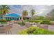 Expansive clubhouse exterior showcasing lush landscaping, outdoor seating, and inviting spaces for relaxation and socializing at 7319 Westminster Ct, University Park, FL 34201