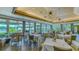 Elegant dining room with large windows, stylish chandeliers, and neatly arranged tables at 7319 Westminster Ct, University Park, FL 34201