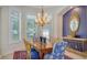 Elegant dining room with natural light, a chandelier, and ornate mirror for a luxurious ambiance at 7319 Westminster Ct, University Park, FL 34201