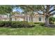 Elegant home with lush lawn, mature trees, and manicured hedges creates inviting curb appeal at 7319 Westminster Ct, University Park, FL 34201