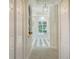 Inviting hallway features neutral tones, bright lighting and contrasting tile accents at 7319 Westminster Ct, University Park, FL 34201