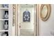 Hallway with decoratively arranged blue plates and a glimpse into other parts of the house at 7319 Westminster Ct, University Park, FL 34201
