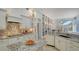 Bright kitchen featuring granite countertops, white cabinets, stainless steel appliances, and a tiled floor at 7319 Westminster Ct, University Park, FL 34201