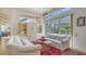 Comfortable living room features built-in shelving, a white sofa, and views of the pool area at 7319 Westminster Ct, University Park, FL 34201