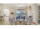 Bright living room features a fireplace, plush seating, and sliding glass doors to the outdoor patio at 7319 Westminster Ct, University Park, FL 34201