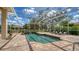 Beautiful screened-in pool with a waterfall feature, perfect for relaxation and outdoor entertainment at 7319 Westminster Ct, University Park, FL 34201