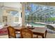 Covered outdoor patio and pool area with lounge chairs and a serene backyard view with lush foliage at 7319 Westminster Ct, University Park, FL 34201