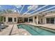 Beautiful backyard featuring a screened pool, brick pavers, and access to a cozy outdoor dining area with comfortable seating at 7319 Westminster Ct, University Park, FL 34201