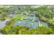 Aerial view of multiple tennis courts surrounded by beautiful landscaping and mature trees at 7319 Westminster Ct, University Park, FL 34201