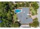 Aerial view of the home showcasing the backyard pool and the roof's unique architecture at 734 Indian Beach Cir, Sarasota, FL 34234