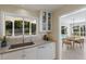 Modern white kitchen with a view of the back yard at 734 Indian Beach Cir, Sarasota, FL 34234
