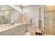 Bathroom featuring double sinks, a large mirror, walk-in shower, and vanity at 8263 Nice Way, Sarasota, FL 34238