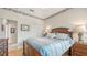 Comfortable bedroom with wood floors, a floral wallpaper border, and bright natural light at 8263 Nice Way, Sarasota, FL 34238