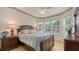 Bright bedroom featuring a decorative wallpaper border, wood floors, and a large window at 8263 Nice Way, Sarasota, FL 34238