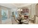 Open dining area with modern decor and a view into the adjacent living space at 8263 Nice Way, Sarasota, FL 34238