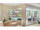 Dining area with pool view, pendant lighting, and seating for four at 8263 Nice Way, Sarasota, FL 34238
