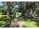 Outdoor exercise area next to a serene lake, surrounded by mature trees and lush greenery at 8263 Nice Way, Sarasota, FL 34238