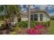 Beautiful landscaping and mature trees surround the exterior of this charming home at 8263 Nice Way, Sarasota, FL 34238