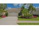 Charming single-story home with lush landscaping and a spacious two-car garage at 8263 Nice Way, Sarasota, FL 34238