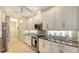 Well-lit kitchen with stainless steel appliances, granite countertops, and white cabinetry at 8263 Nice Way, Sarasota, FL 34238