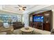 Relaxing living room with a comfortable seating area and entertainment center with a TV at 8263 Nice Way, Sarasota, FL 34238