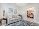 Sitting room featuring cozy seating, neutral walls, and seamless flow to dining room at 8263 Nice Way, Sarasota, FL 34238