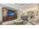 Living room with large entertainment center, sofa, and chairs at 8263 Nice Way, Sarasota, FL 34238