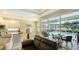 Open-concept living room with kitchen, dining area, and screened-in lanai with a pool at 8263 Nice Way, Sarasota, FL 34238