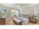 Bright main bedroom with a sitting area, ceiling fan, and lots of natural light at 8263 Nice Way, Sarasota, FL 34238