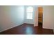 Bedroom with wood-look flooring, a bright window, and closet at 8325 38Th Street E Cir # 101, Sarasota, FL 34243